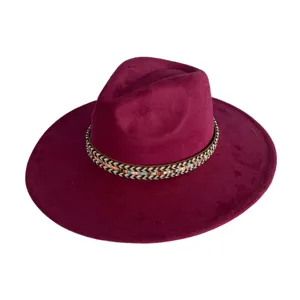 Detailed view of a retro wide-brim suede fedora hat in burgundy with a woven boho hat band.