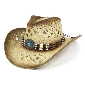 Close-up detail of a bohemian straw western cowboy hat featuring intricate beaded decorative band.