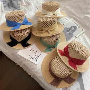 Chic straw hat featuring a delicate bowknot, hallow-out design, and elegant style for beach.