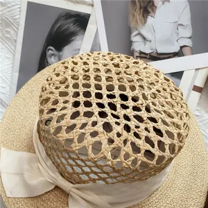 Raffia straw hat with a white ribbon bow, hollow crown flat top sun hat for beach vacation.