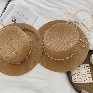 Summer straw boater hat with pearl and ethnic ribbon, stylish flat top sun hat for beach travel.