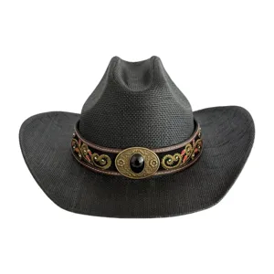 Close-up of the vintage embroidered hatband and ornate metal buckle on a black western cowboy hat.