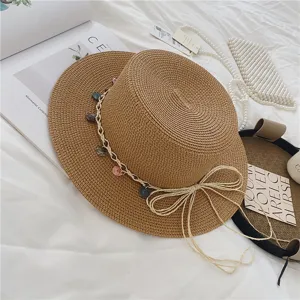 Woven straw boater hat with colorful bead charm band and bow detail for summer beach vacation.