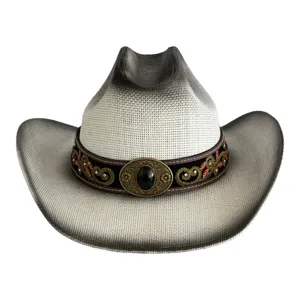Close-up detail of the vintage western cowboy straw hat with embroidered band and metal buckle.