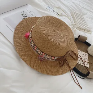 Summer bohemian straw hat with colorful woven band and tassels, perfect for beach and vacation.