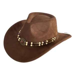 Brown suede western cowboy hat detail featuring beaded band and vintage metal medallion decor.