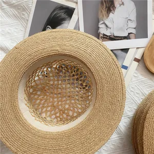 Raffia hollow flat top straw hat detail, perfect for beach vacation and summer sun protection.