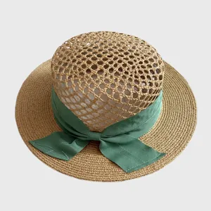 Woven straw hat for women with green ribbon bow, hollow top beach sun hat for summer holiday.