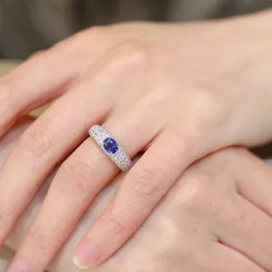 Close-up detail view of the classic oval sapphire ring with micro-pave stones.