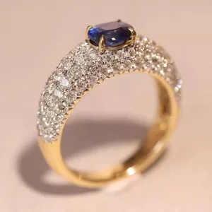 Elegant wide dome pave ring featuring a stunning center blue stone and sparkling cubic zirconia.