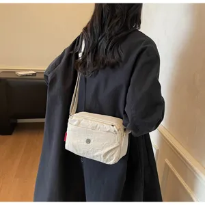 Casual nylon shoulder bag detail view, minimalist solid color crossbody design for daily wear.