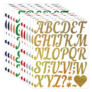 Close up detail of sparkling gold glitter alphabet letter stickers showing glossy texture.