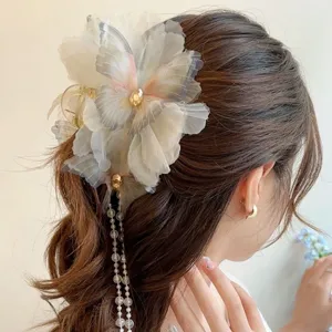 Exquisite French-style large feather hair claw clip with elegant tassel pearl details for women.