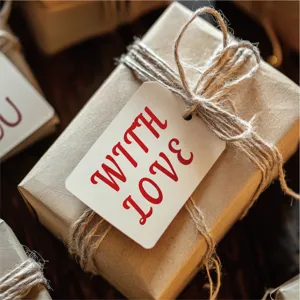 Detailed close-up shot of a rustic kraft paper gift box wrapped with natural twine and a tag.