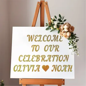 Detailed view of gold glitter letter stickers on a white sign with floral decor for weddings.