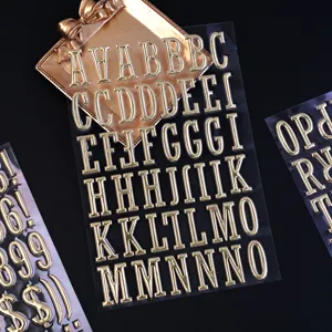 3D metallic gold letter stickers, transparent DIY alphabet sticker sheets for scrapbooking decor.