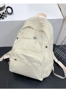Sac à dos décontracté minimaliste en nylon avec plusieurs poches zippées pour le voyage.