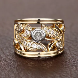 Close-up detail of the wide two-tone cutout leaf ring sparkling with delicate zircons.