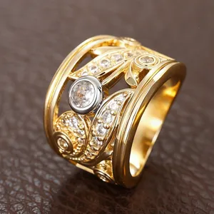 Detail shot of wide band hollow leaf pattern ring, gold plated two-tone cubic zirconia jewelry.