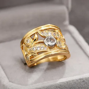 Detail shot of a wide hollow leaf zircon ring, two-tone gold plated fashion jewelry.