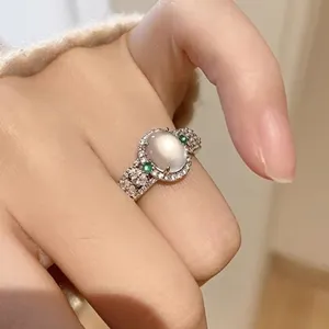 Detailed view of French vintage style oval moonstone ring with sparkling cubic zirconia crystals.