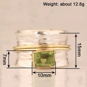 Vista detallada del anillo ancho bicolor con gema verde y un peso aproximado de 12,8 gramos.
