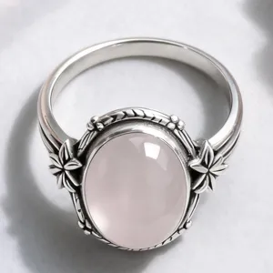 Vintage silver ring with oval pink stone and floral design, stylish jewelry for women.