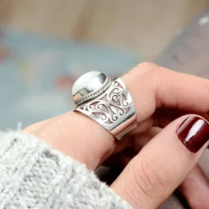 Detailed view of ethnic vintage women ring with hollow carved copper and white moonstone design.