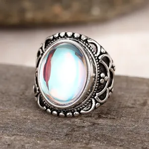 Vintage retro palace style silver carved ring with colorful iridescent oval gemstone detail shot