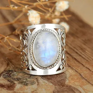 Exquisite vintage style wide silver ring with oval moonstone and intricate hollow carved patterns.