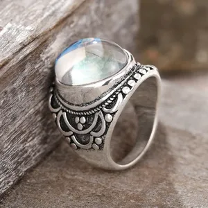 Vintage silver carved ring with domed moonstone, retro palace style ring close-up detail.