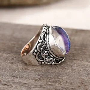 Vintage silver-plated court style ring with an embossed carved band and colorful stone detail.