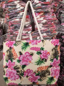 Detailed shot of a tropical floral canvas tote bag with thick rope handles and vibrant print.