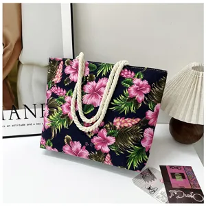 Tropical floral canvas tote bag detail, pink hibiscus pattern with thick rope handle.