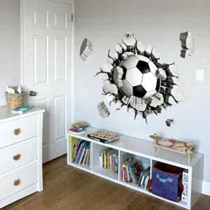 3D broken wall soccer sticker detail shot, showing the realistic football wall decal in room.