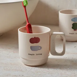 Simple minimalist toothbrush cup with cute cartoon print and comfortable handle for bathroom use.