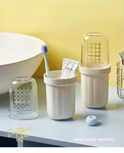 Portable travel toothbrush cup and holder set with clean aesthetic design for bathroom use.