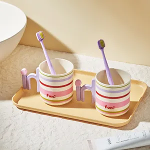 Striped gargle cups set with creative handles and toothbrush holder tray for home bathroom use.
