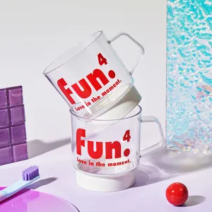 Clear plastic mouthwash cup set with white base and red letter print, stacked for travel use