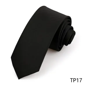 Close-up of black herringbone necktie fabric, premium texture detail view for formal wear.