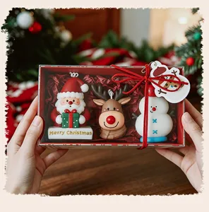 Detailed close-up of Christmas scented candle gift set with cute Santa and snowman figurines.