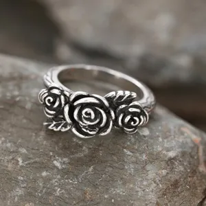 Vintage silver-tone rose flower ring, detailed retro rock aesthetic statement jewelry piece.