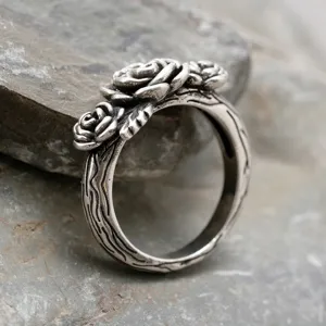 Vintage silver rose ring close-up display, detailed gothic floral jewelry shot.
