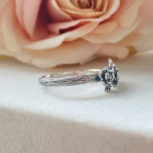 Vintage silver rose ring with textured tree bark band, elegant retro niche style jewelry.