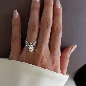 Detailed close-up showing the exquisite marquise cut stone and sparkling V-shaped ring band.