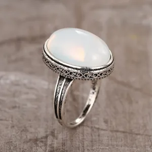 Vintage silver-plated ring featuring an elegant translucent oval imitation moonstone gem.