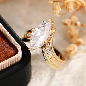 Close-up view of a stunning marquise cut ring with a unique V-shaped design and sparkling stones.