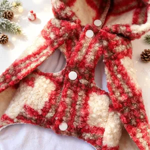 Cozy red and white curly fleece pet Christmas cape with hood and snap buttons detail.