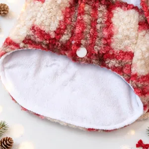 Detailed view of red white plaid pet fleece winter cloak with soft warm inner lining.