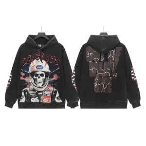Vintage washed black streetwear hoodie showing detailed front skull graphic and back text.